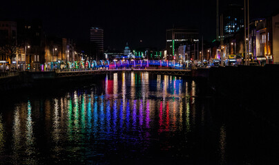 Fototapeta premium Vibrant City Lights Reflecting on River Liffey in Dublin at Night