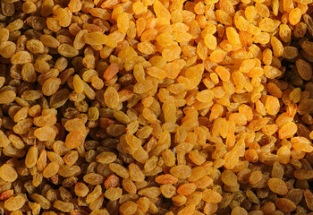 Pile of dried yellow raisins. Sultani raisins. Dried golden raisins background. Organic golden raisins texture. in indian market