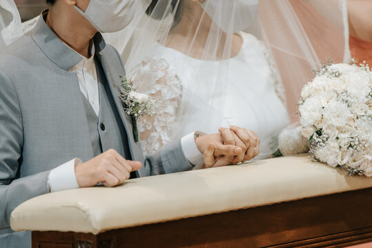 closeup bride and groom holding hands