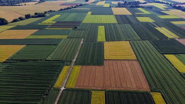 Agricultural landscape showing a patchwork of different crops creating a colorful geometric pattern