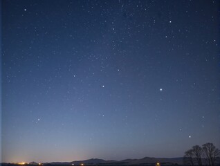 Obraz premium Clear Night Sky Full of Stars Over a Tranquil Horizon with Subtle Twilight Glow