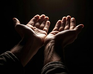 Open hands with their palms outstretched on a dark background