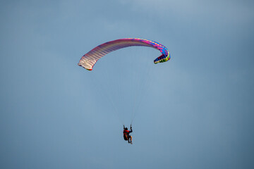 Parachute is filling with air in the mountains alps on a sunny day
