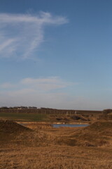 Obraz premium A field with a river running through it
