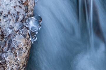 Winter cascade framed by icicles, Orangeville Creek, Michigan, USA