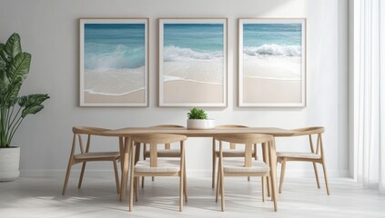 Fototapeta premium Minimalist dining room with three framed ocean posters above an oak table, natural light, and a green plant