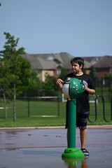 wet boy on fountain and splashes,
