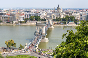 Obraz premium The Pest side of Budapest with St. Stephen's Basilica, the Chain Bridge open to pedestrian tourists, and the Danube