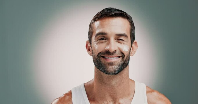 Skincare, natural and man with face cream in studio for health, wellness and facial routine. Moisturizer, portrait and person with dermatology treatment with spf or sunscreen by gray background.