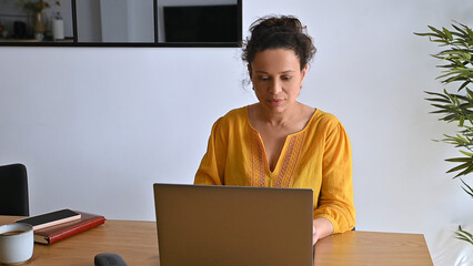 Woman Working Remotely on Laptop in Comfortable Modern Home Office