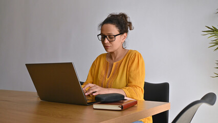 Entrepreneur Working Remotely From Home Using Laptop in Modern Cozy Interior