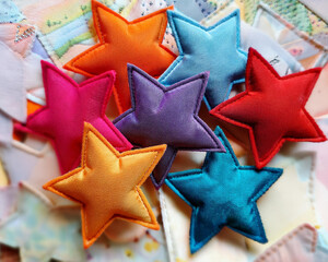 Obraz premium Clusters of colorful cloth star patches in a selection of vivid hues.