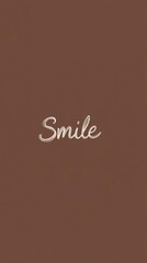 
The word "Smile" in cursive on a solid brown background, a simple and minimalist wallpaper for a mobile phone with copy space.


