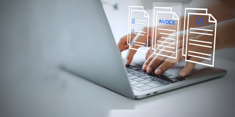 A business person using laptop with visual screen E-Invoice and Digital billing concept,Online invoice processing and tax accounting solutions. 