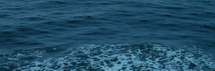 Fototapeta premium Ocean's Embrace: Capturing the movement of the sea, this image portrays the raw power and endless allure of the ocean, as waves crash in a seamless display of nature's artistry.