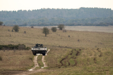 a British army General Dynamics Ajax Ares tank being tested in countryside