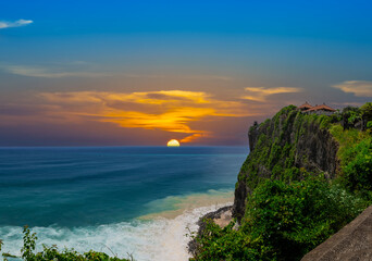 Uluwatu Temple in Bali the land of the Gods. Sitting on top of a forest cliff overlooking turquoise...