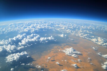 Fototapeta premium Aerial View of the Horizon with Fluffy White Clouds Stretching into an Endless Sky, Captured at Sunset for Warm Pastel Hues