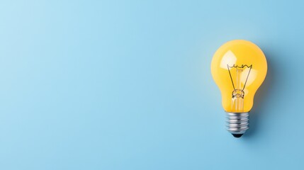 Bright Yellow Light Bulb Against a Soft Blue Background Showcasing Innovation and Creativity in Design
