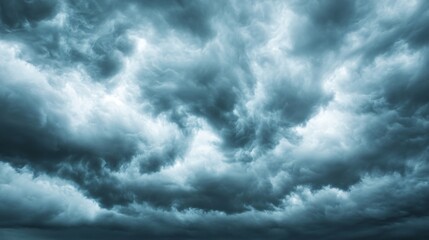 Dramatic stormy sky, swirling gray clouds with hints of blue, perfect for capturing the essence of nature's power.