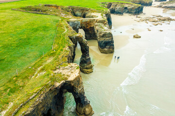 Natural rock arches Cathedrals beach, Playa de las Catedrales at Ribadeo, Galicia, Spain. Famous beach in Northern Spain Atlantic. Natural rock arch on Cathedrals beach in low tide © proslgn
