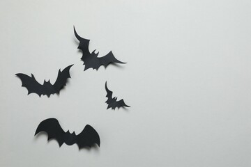 Black bats on a gray background. Halloween concept