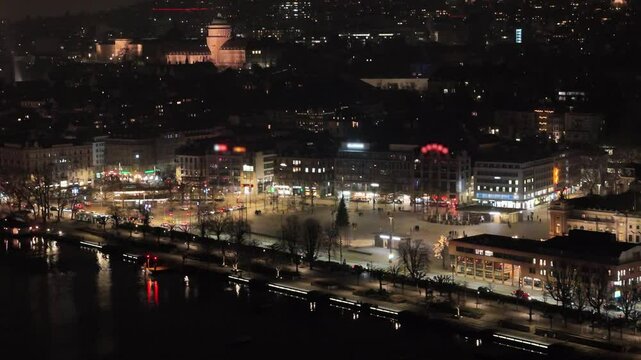 upwards over zurich's town center night includes sechsel utenplatz eth zurich surrounding churches under dark skies aerial drone panning shot view university city switzerland 