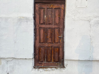 An old wooden door in a concrete building