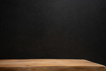 Wood table on black wall background for advertising, digital content, and design templates..
