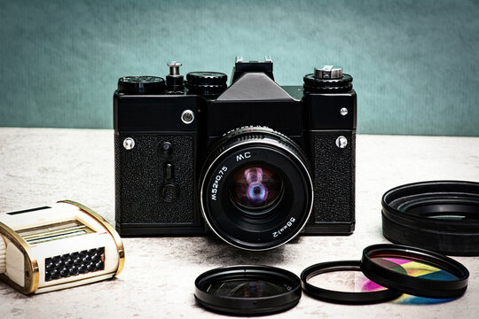 A nostalgic manual SLR camera for films with various filters and a light meter.