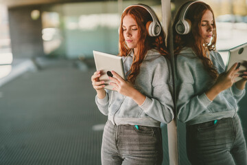 A Young Woman Joyfully Relishing Music While Using Her Tablet in a Modern and Stylish Setting
