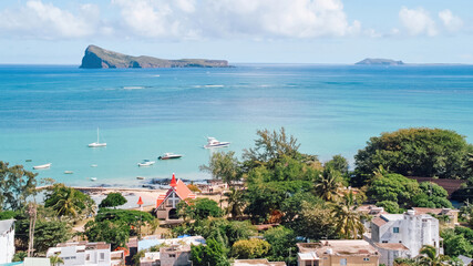 Obraz premium Stunning aerial view of Gunner's Quoin (Coin de Mire) Island and the iconic red-roofed church on the beach at Cap Malheureux, Mauritius