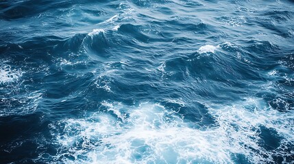 Deep blue ocean waves with whitecaps.