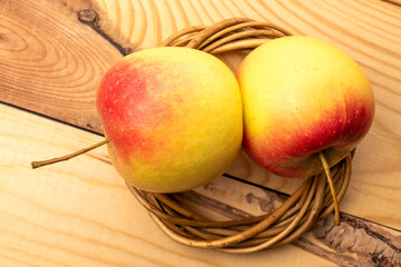 Two juicy apples on a wooden table, close-up, top view.