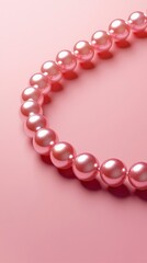 Obraz premium Pink Pearl Necklace on Pink Background