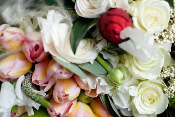Beautiful holiday card. Mother Day greeting card. Delicate bouquet of white ranunculus and pastel tulips with soft green leaves, creating a romantic and elegant floral scene