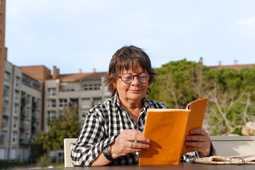 Retirement and free time reading a book on sant jordi