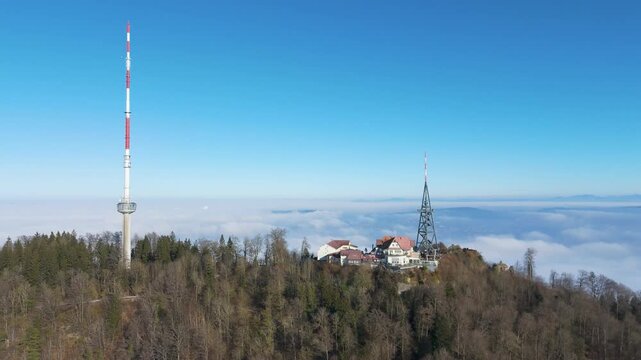 uetliberg mountain peak hotel restaurant communication tower zurich switzerland appears background clouds fog through aerial drone foggy swiss alps cultural significance 