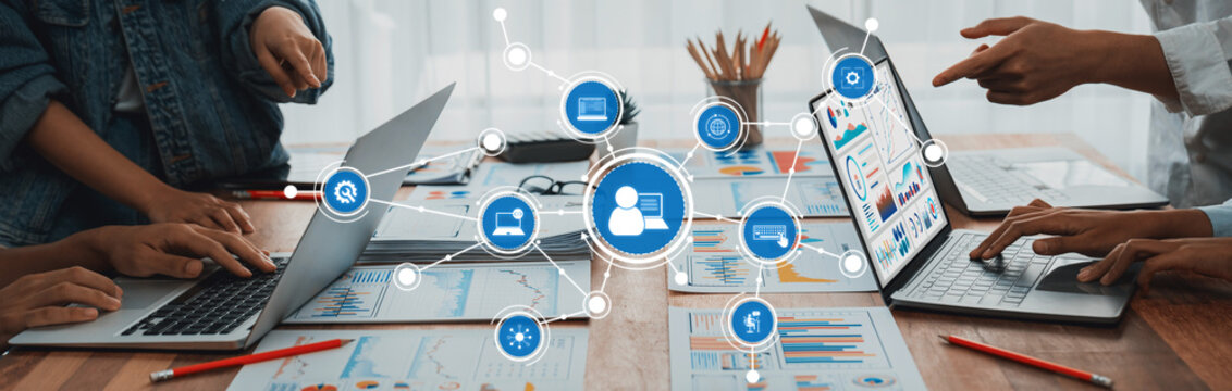 Panorama shot analyst team utilizing BI Fintech to analyze financial report with laptop. Businesspeople analyzing BI power dashboard displayed on laptop screen for business insight. Scrutinize Amity