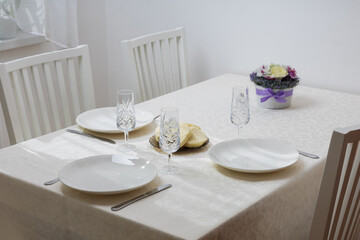 A table set for lunch. Plates on a white tablecloth