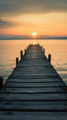 Obraz premium Serene wooden pier stretches into the horizon at sunset, inviting tranquility and reflection