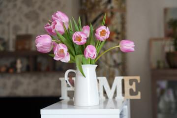 Sign Home text on lightbox , pink flowers tulip in vase, decorative frame modern interior background, stylish house cozy