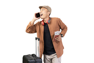 Naklejka premium Young Indonesian male traveler is on voice call while carrying suitcase while traveling, travel concept, isolated on white background.