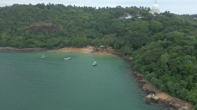 Aerial view of tropical Jungle Beach in Unawatuna Sri Lanka. Panoramic view of exotic coastline and tropical forest. Paradise Beach.