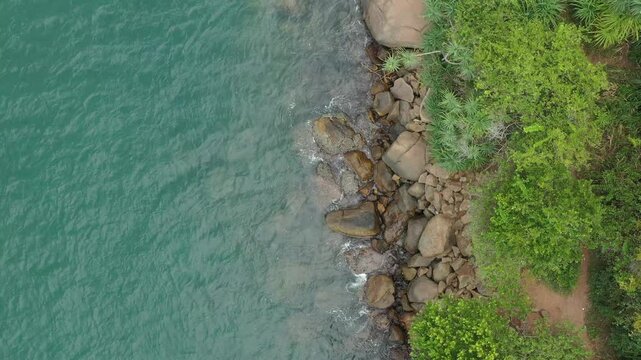 Aerial view of tropical Jungle Beach in Unawatuna Sri Lanka. Panoramic view of exotic coastline and tropical forest. Paradise Beach.