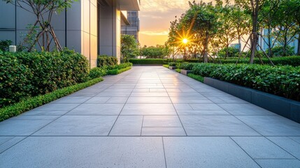 Obraz premium Modern building exterior with landscaped pathway at sunset