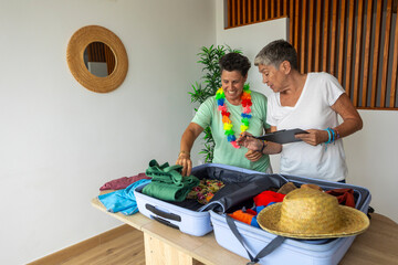 mature lesbian couple packing for a tropical vacation