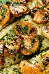 Close-up of baked zucchini with mushrooms and cheese, sprinkled with fresh chopped parsley, focus on the middle