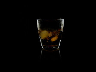 glass of whiskey on black background