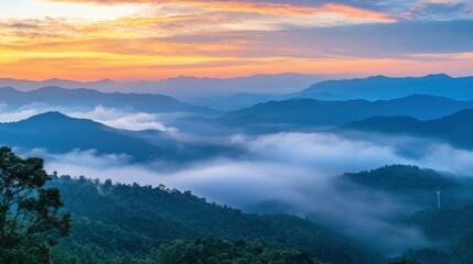 Fototapeta premium Beautiful fog mountain landscape and wind generators turbines at sunset, Khao Kho mountain, Thailand. Renewable energy concept.
